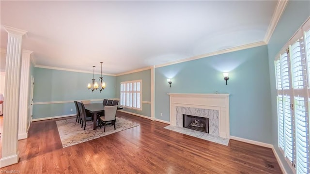 1005 Fallbrook Ln, Lewisville, NC 27023 - dining area featuring wood finished floors, crown molding, a chandelier, and baseboards