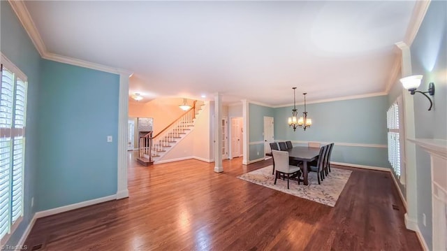 1005 Fallbrook Ln, Lewisville, NC 27023 - dining room with stairway, baseboards, wood finished floors, crown molding, and a chandelier