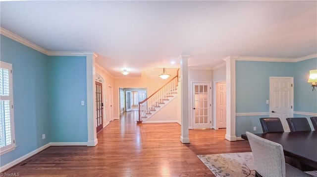 1005 Fallbrook Ln, Lewisville, NC 27023 - unfurnished dining area with stairway, plenty of natural light, wood finished floors, and crown molding