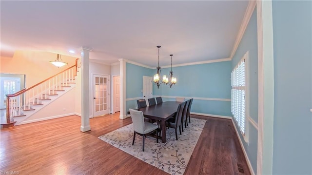 1005 Fallbrook Ln, Lewisville, NC 27023 - dining space featuring stairway, crown molding, baseboards, wood finished floors, and a chandelier