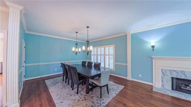 1005 Fallbrook Ln, Lewisville, NC 27023 - dining space with wood finished floors, a chandelier, crown molding, baseboards, and a premium fireplace