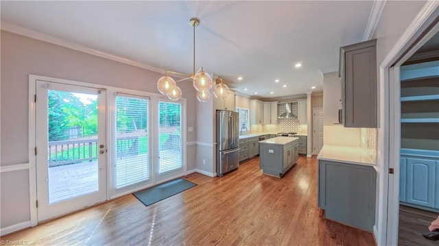 1005 Fallbrook Ln, Lewisville, NC 27023 - kitchen with freestanding refrigerator, light countertops, gray cabinets, a kitchen island, and backsplash