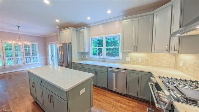 1005 Fallbrook Ln, Lewisville, NC 27023 - kitchen with appliances with stainless steel finishes, wall chimney exhaust hood, crown molding, tasteful backsplash, and a sink