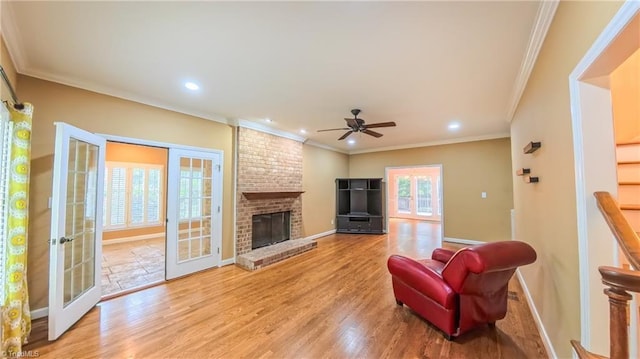 1005 Fallbrook Ln, Lewisville, NC 27023 - living room with crown molding, light wood-style floors, a ceiling fan, baseboards, and recessed lighting
