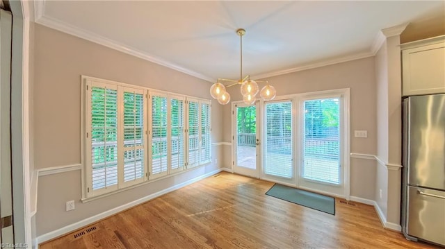 1005 Fallbrook Ln, Lewisville, NC 27023 - unfurnished dining area featuring crown molding, light wood finished floors, a chandelier, and baseboards