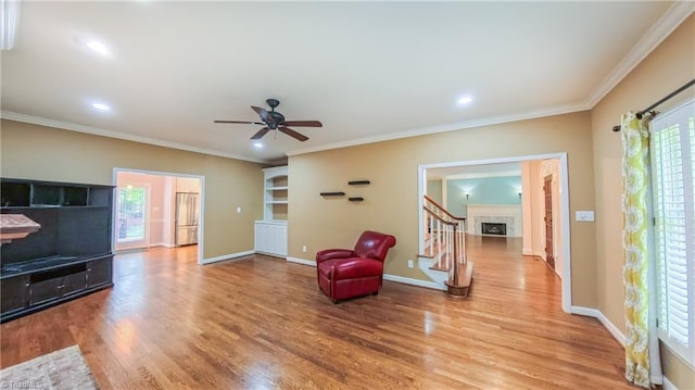 1005 Fallbrook Ln, Lewisville, NC 27023 - living area featuring wood finished floors, ceiling fan, baseboards, crown molding, and recessed lighting