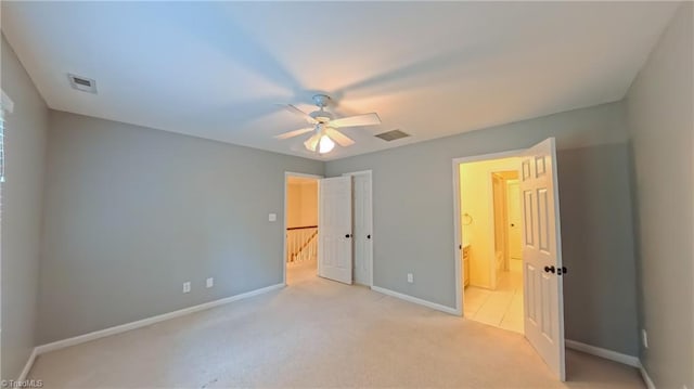 1005 Fallbrook Ln, Lewisville, NC 27023 - unfurnished bedroom with baseboards, light colored carpet, a ceiling fan, and connected bathroom