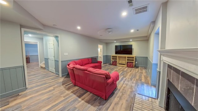 1005 Fallbrook Ln, Lewisville, NC 27023 - living area featuring a fireplace, a wainscoted wall, wood finished floors, and recessed lighting
