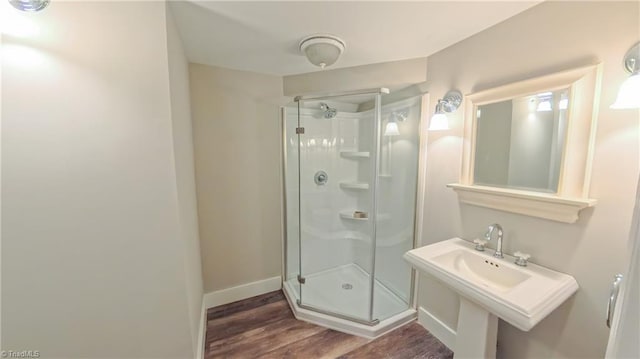 1005 Fallbrook Ln, Lewisville, NC 27023 - bathroom with a stall shower, wood finished floors, and baseboards