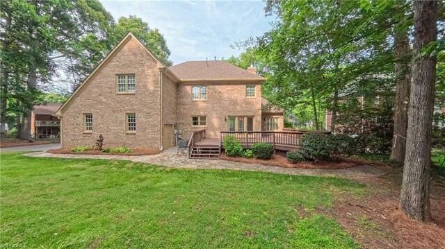 1005 Fallbrook Ln, Lewisville, NC 27023 - rear view of house with a deck, a yard, and a chimney