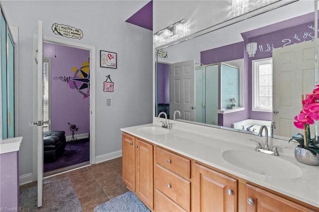 bathroom with a stall shower, tile patterned flooring, a sink, and double vanity