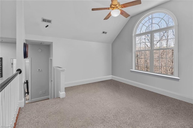 bonus room featuring baseboards, visible vents, vaulted ceiling, and carpet flooring