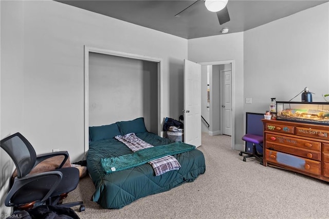 bedroom with baseboards, a ceiling fan, and light colored carpet