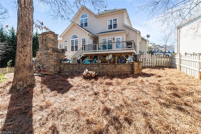 back of property featuring stairway, fence private yard, and a wooden deck