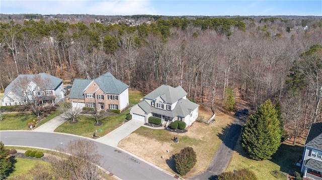 drone / aerial view featuring a forest view