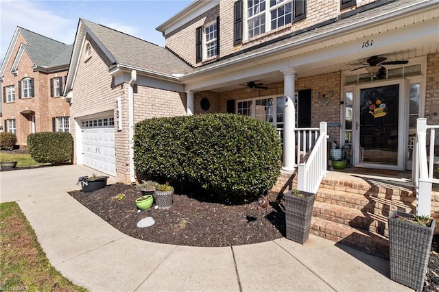 view of front facade with driveway, ceiling fan, and brick siding