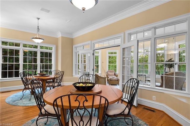 344 Lake Point Ln, Belews Creek, NC 27009 - dining space with crown molding, light wood finished floors, and baseboards