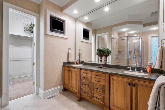 344 Lake Point Ln, Belews Creek, NC 27009 - bathroom featuring ornamental molding, a shower stall, double vanity, tile patterned floors, and baseboards