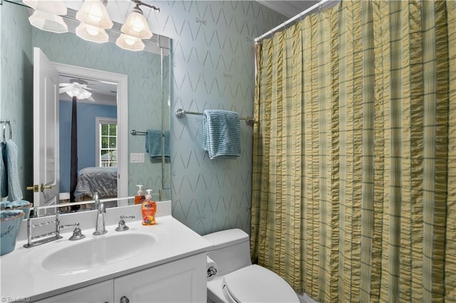 344 Lake Point Ln, Belews Creek, NC 27009 - bathroom with wallpapered walls, vanity, connected bathroom, toilet, and curtained shower