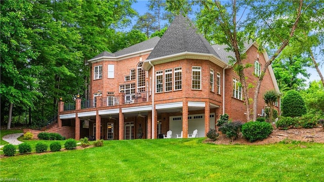 344 Lake Point Ln, Belews Creek, NC 27009 - back of house featuring a yard, brick siding, and an attached garage