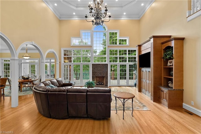 344 Lake Point Ln, Belews Creek, NC 27009 - living room with ornamental molding, a high ceiling, light wood-type flooring, a chandelier, and french doors