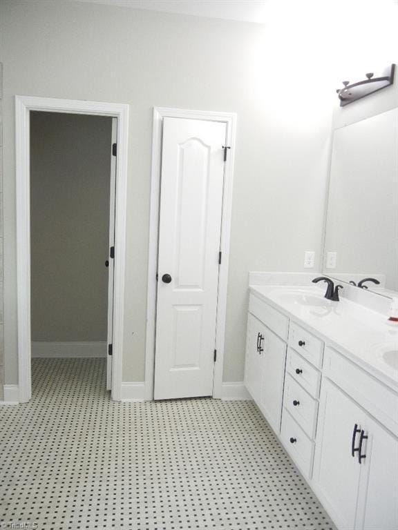 715 Cannonade Dr, Whitsett, NC 27377 - bathroom with double vanity and baseboards