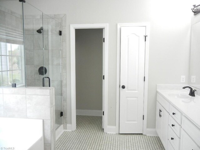 715 Cannonade Dr, Whitsett, NC 27377 - full bathroom featuring vanity, a shower stall, a bath, and tile patterned floors