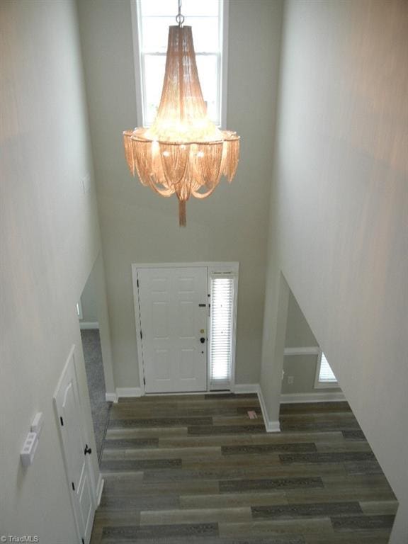 715 Cannonade Dr, Whitsett, NC 27377 - entrance foyer featuring wood finished floors, a high ceiling, and a chandelier