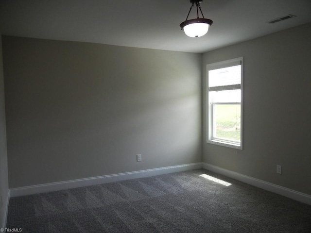 715 Cannonade Dr, Whitsett, NC 27377 - unfurnished room featuring dark carpet and baseboards