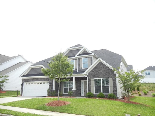 715 Cannonade Dr, Whitsett, NC 27377 - view of front facade with stone siding, an attached garage, a front yard, and concrete driveway