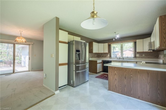 kitchen with stainless steel fridge with ice dispenser, dishwasher, light countertops, a sink, and a peninsula