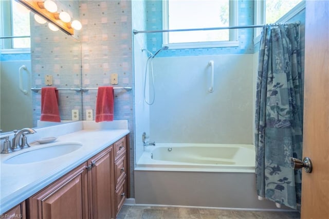 bathroom with shower / bath combo with shower curtain and vanity