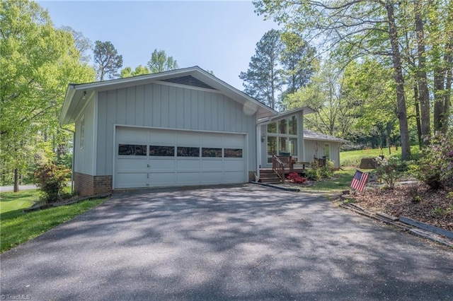 view of home's exterior featuring driveway and an attached garage