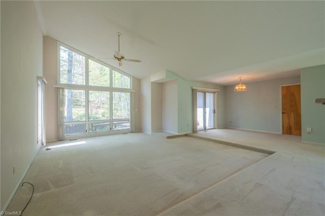 unfurnished living room featuring carpet flooring, high vaulted ceiling, a ceiling fan, a chandelier, and baseboards