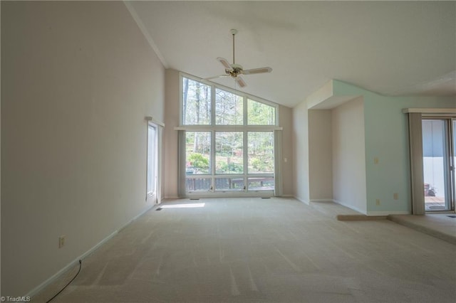 spare room with a ceiling fan, light carpet, high vaulted ceiling, and plenty of natural light