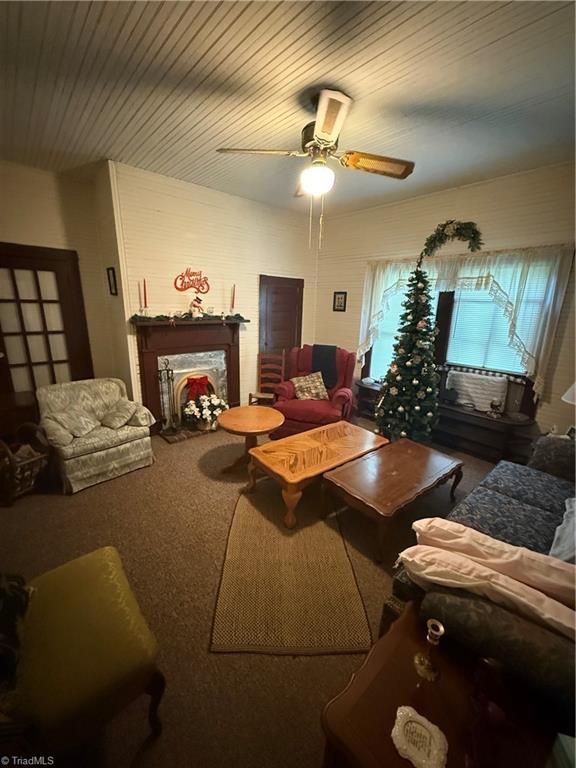 535 Worth St, Mount Airy, NC 27030 - carpeted living room with a fireplace and a ceiling fan