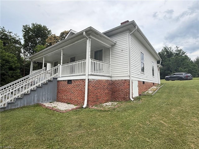 535 Worth St, Mount Airy, NC 27030 - view of side of property featuring a lawn, stairs, crawl space, covered porch, and a chimney