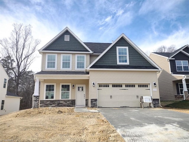 craftsman house with a garage and covered porch