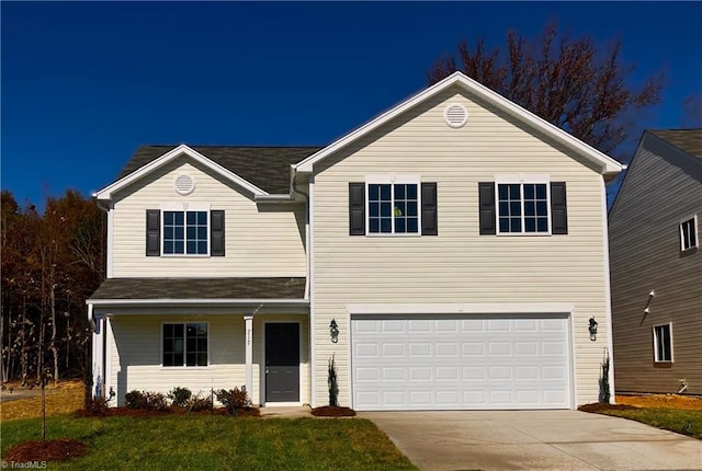 front of property featuring a front lawn and a garage