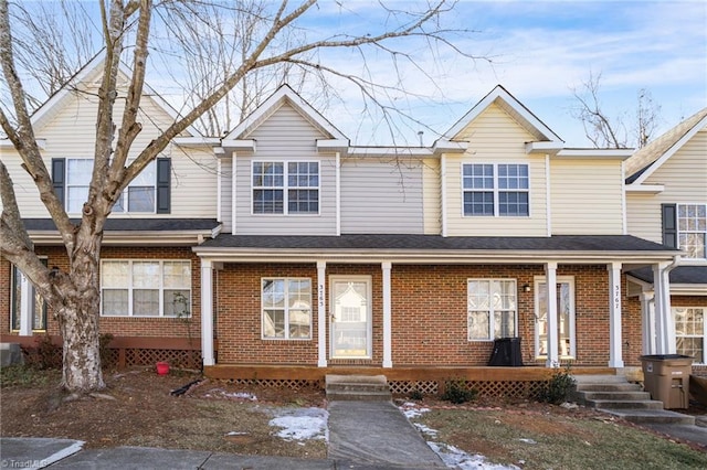 townhome / multi-family property featuring covered porch