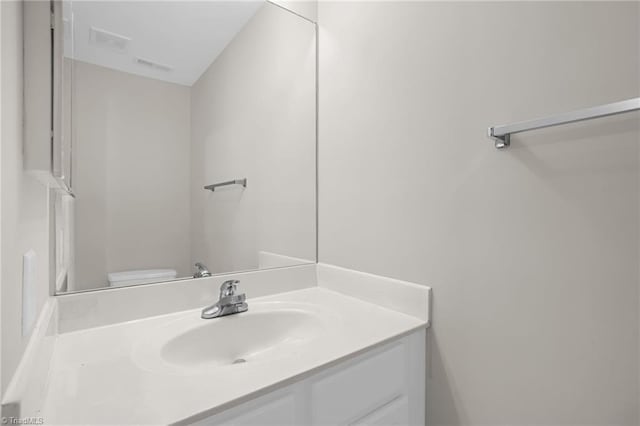 bathroom with toilet and vanity