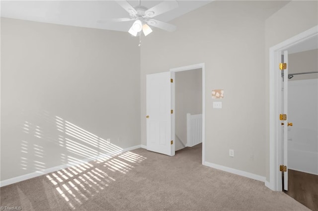 unfurnished bedroom featuring ceiling fan and light carpet