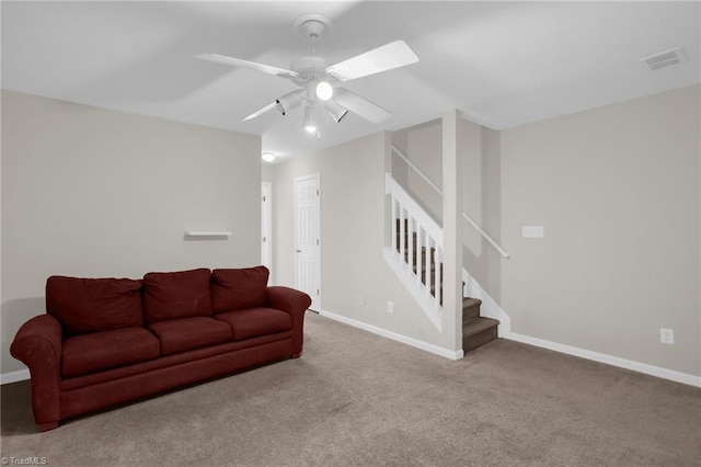 carpeted living room with ceiling fan