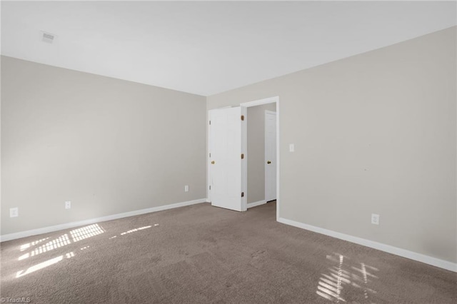 unfurnished room featuring carpet