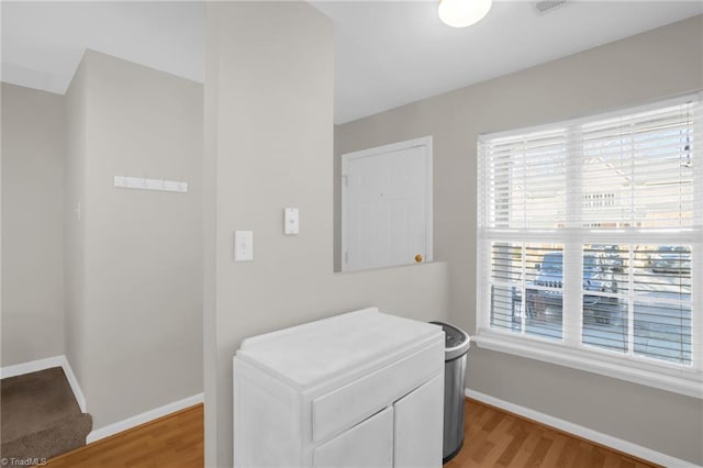 interior space with a wealth of natural light and hardwood / wood-style floors