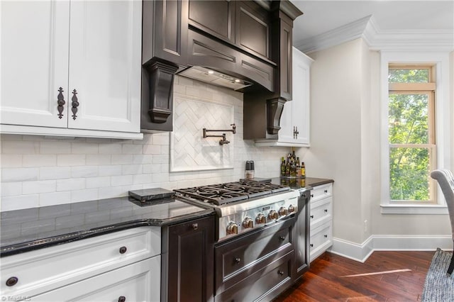 kitchen with ornamental molding, stainless steel gas cooktop, exhaust hood, dark hardwood / wood-style floors, and white cabinetry