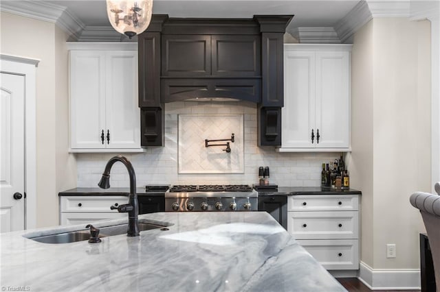 kitchen featuring light stone countertops, white cabinetry, and tasteful backsplash