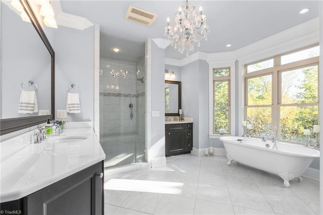 bathroom with a notable chandelier, vanity, crown molding, and independent shower and bath