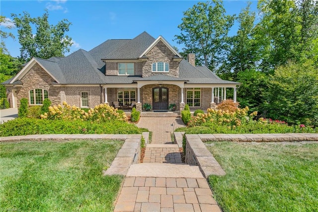 view of front of home featuring a front yard and a porch