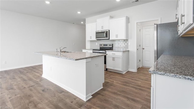 1372 Amberview Ln, Kernersville, NC 27284 - kitchen featuring white cabinets, a sink, appliances with stainless steel finishes, a kitchen island with sink, and backsplash